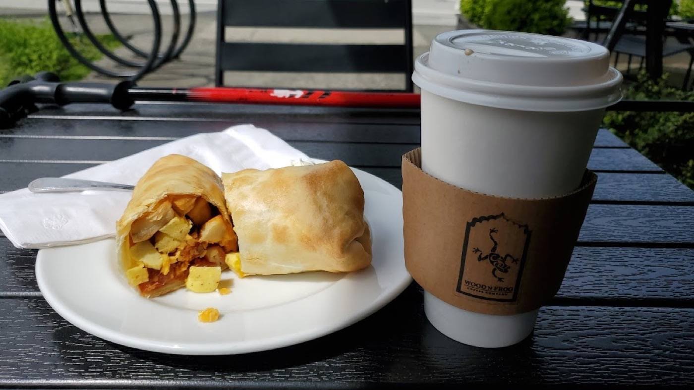 Chorizo hash breakfast wrap with a Wood N Frog coffee on the patio